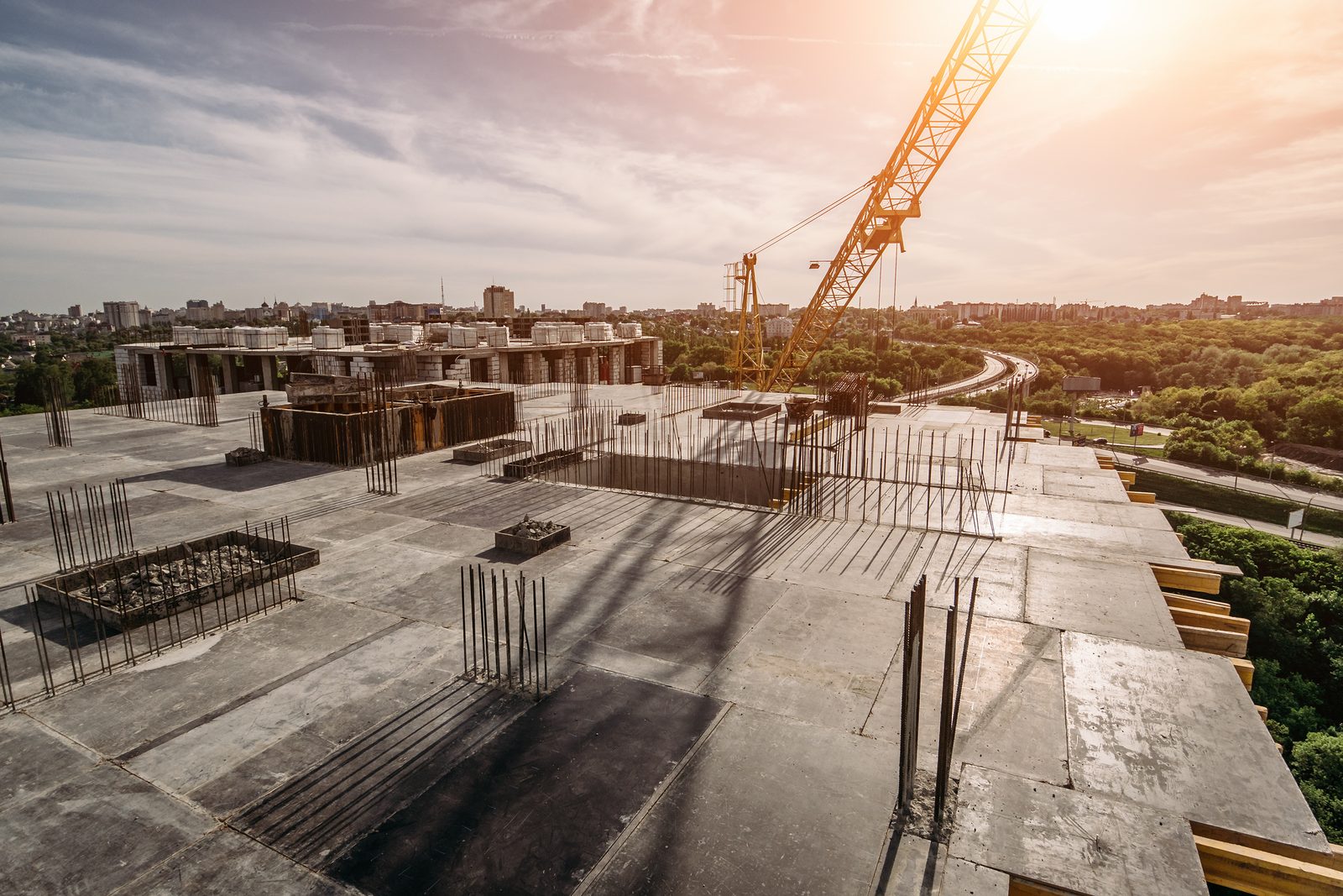 A tower crane over a concrete deck under construction
